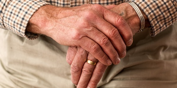 Hands walking stick elderly old person